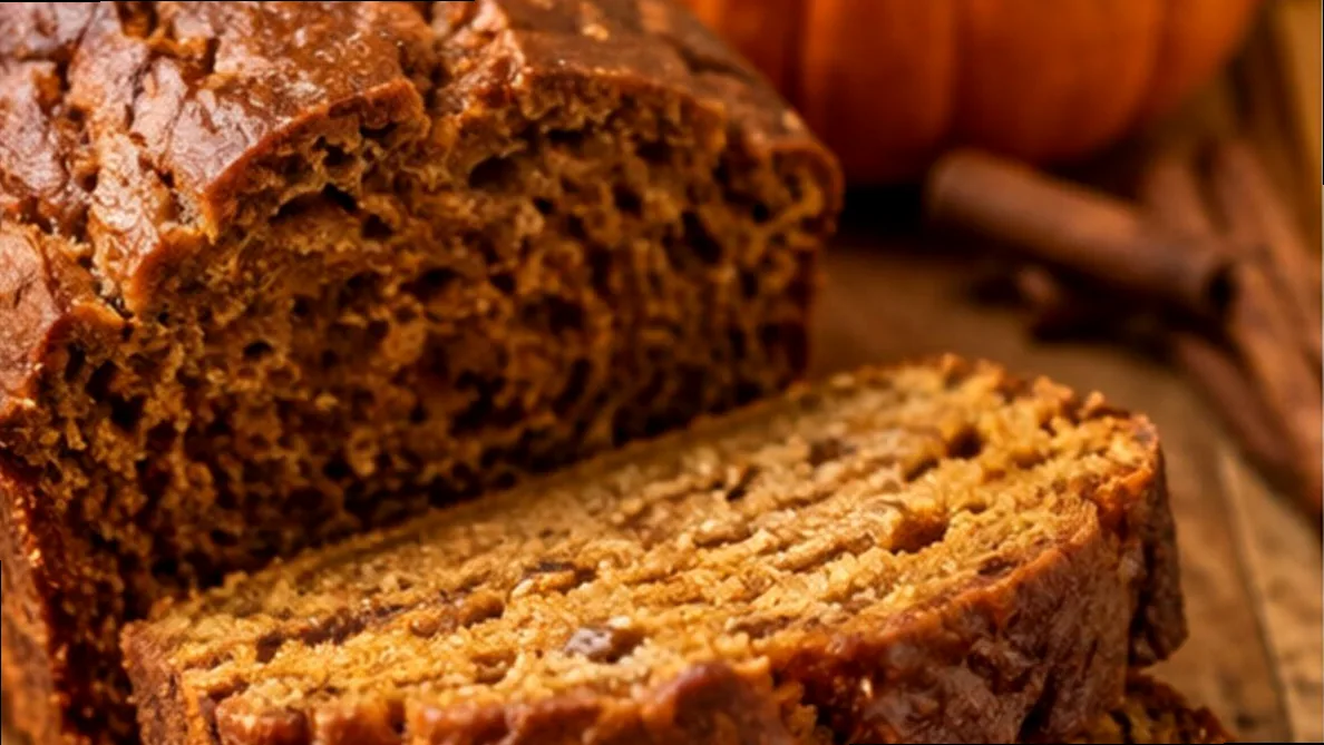 Pumpkin spice bread with a small pumpkin